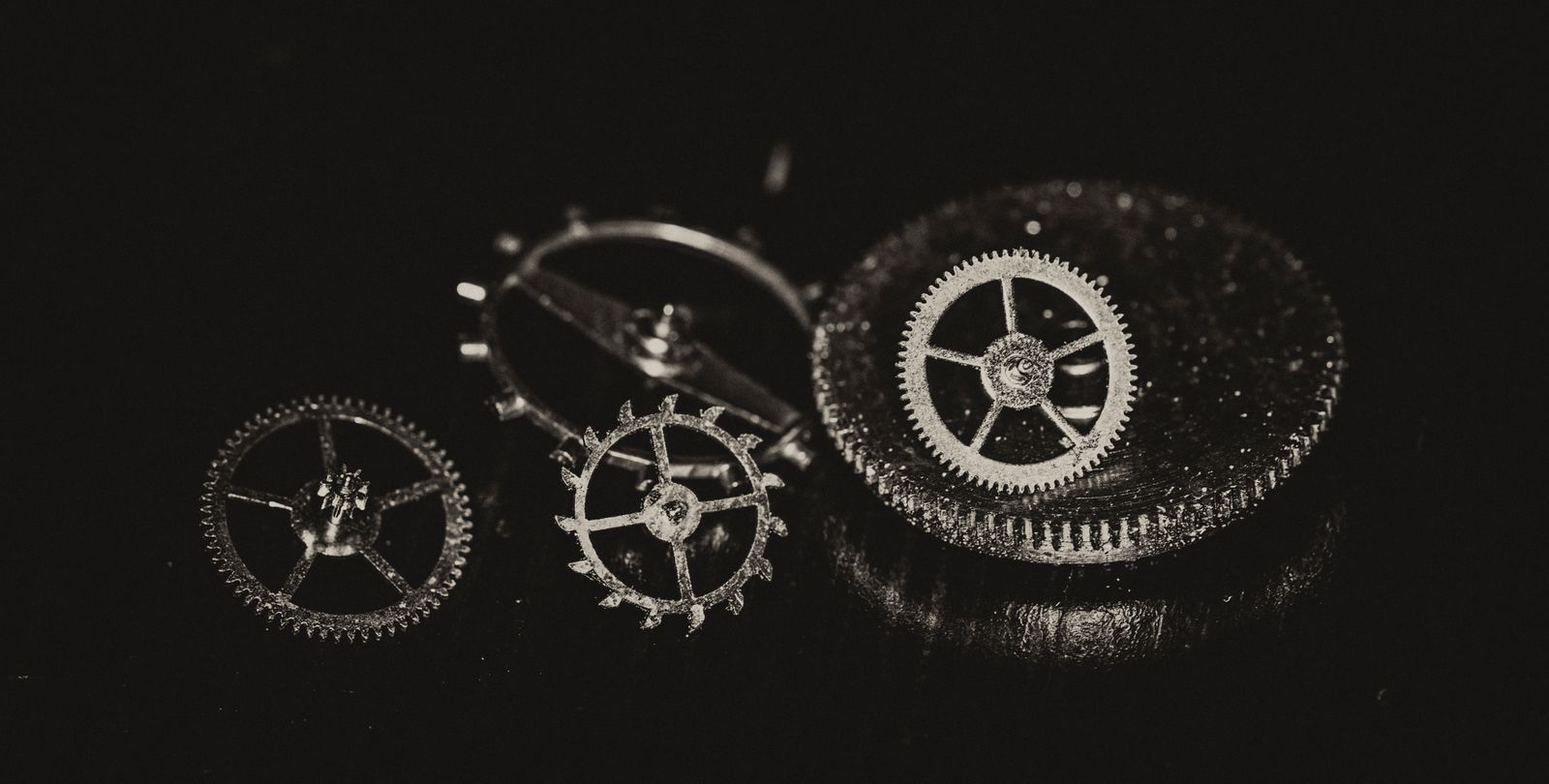 Detailed image showing intricate metal gears and mechanisms with a dark aesthetic.